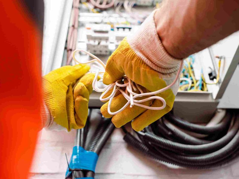 cropped-view-of-electrician-in-gloves-holding-wire-2023-11-27-05-26-14-utc (1)_11zon